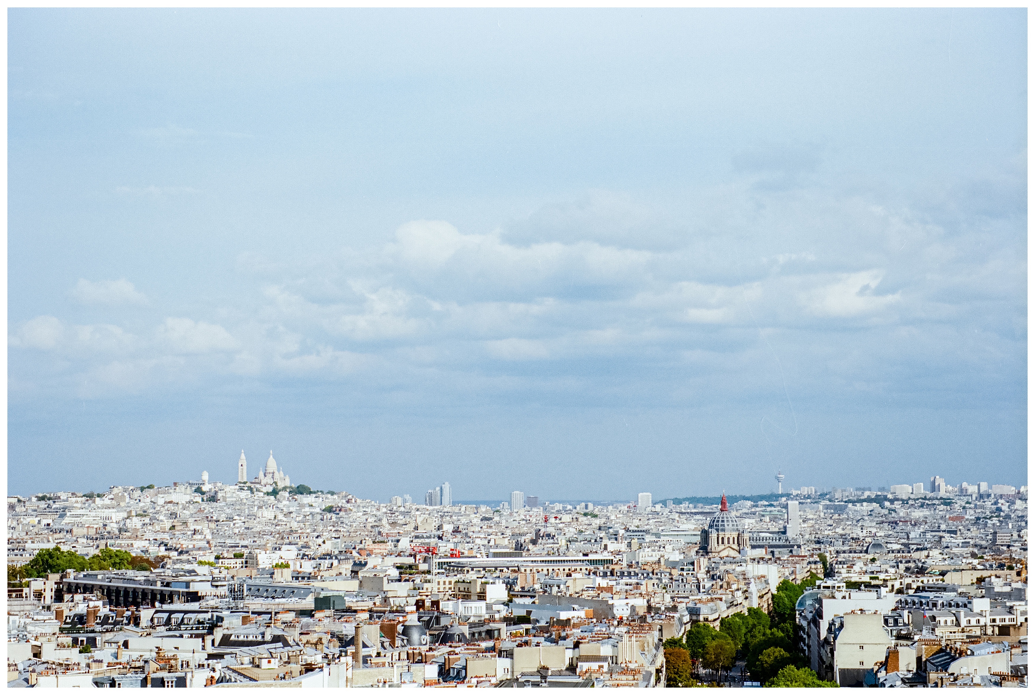 bird's eye view of paris with sacre coeur basilica standing on the hill of montmartre in the distance