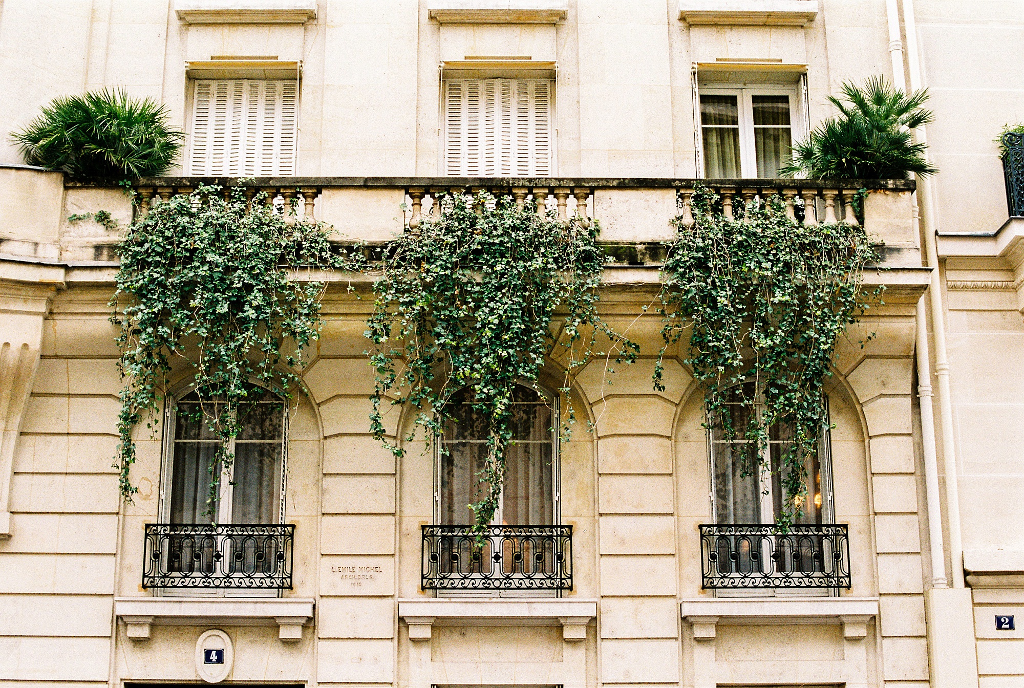A balcony with hanging vines on Avenue de Camoens in Paris 