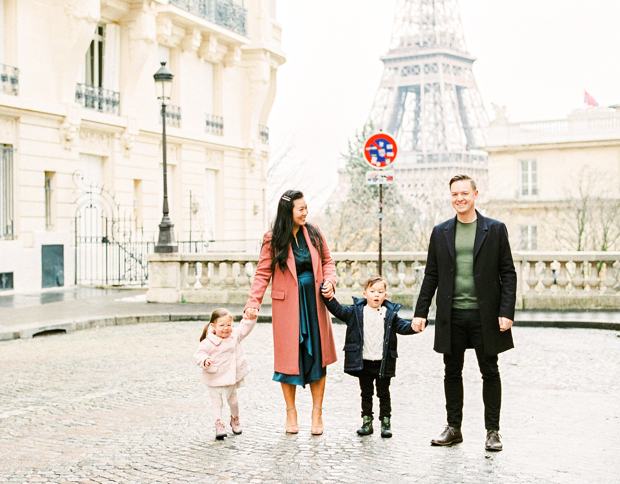 Family of four in front of the Eiffel Tower