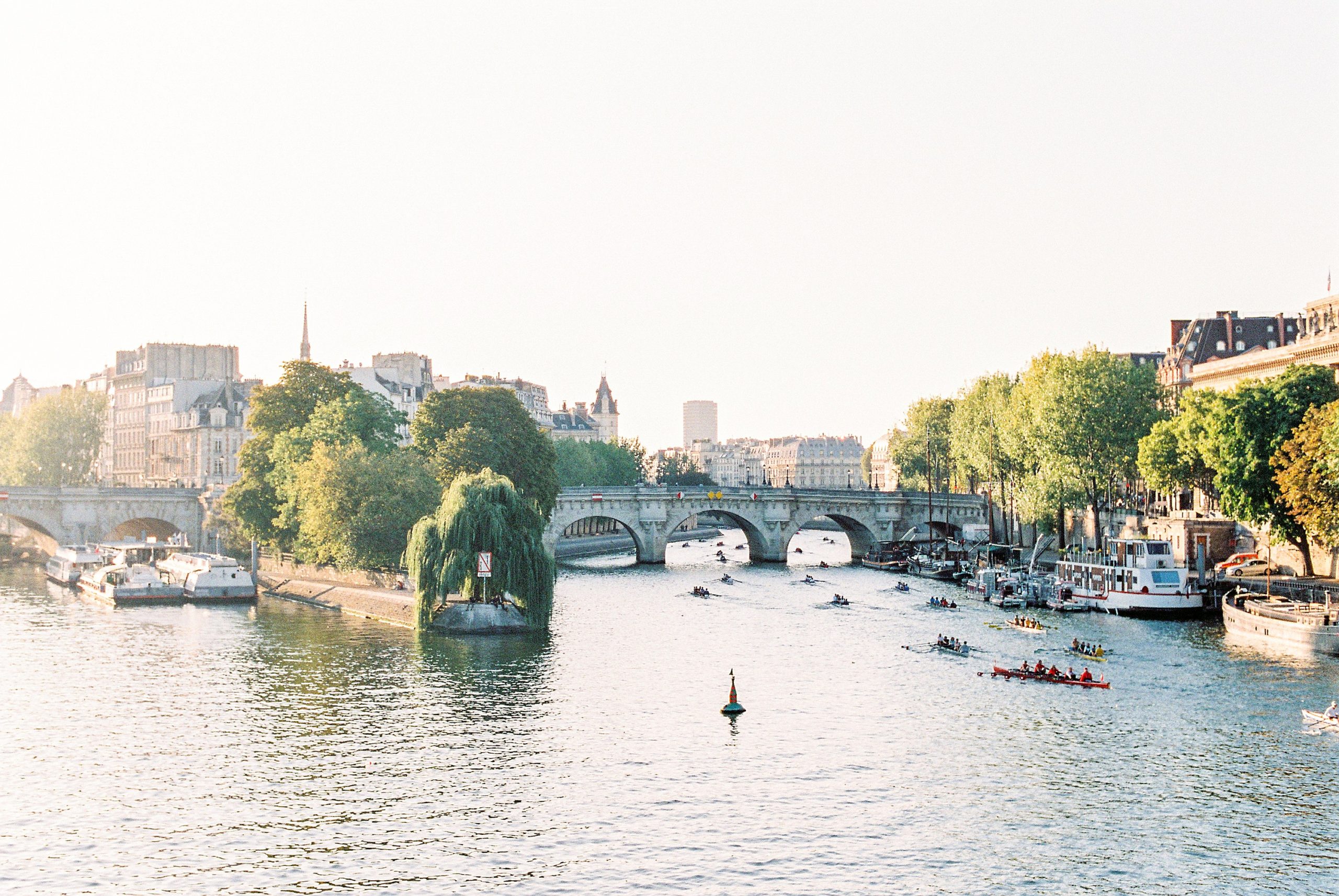 Pont Neuf and Île de la Cité are illuminated by morning light as the Seine glitters on a quiet morning in Paris.