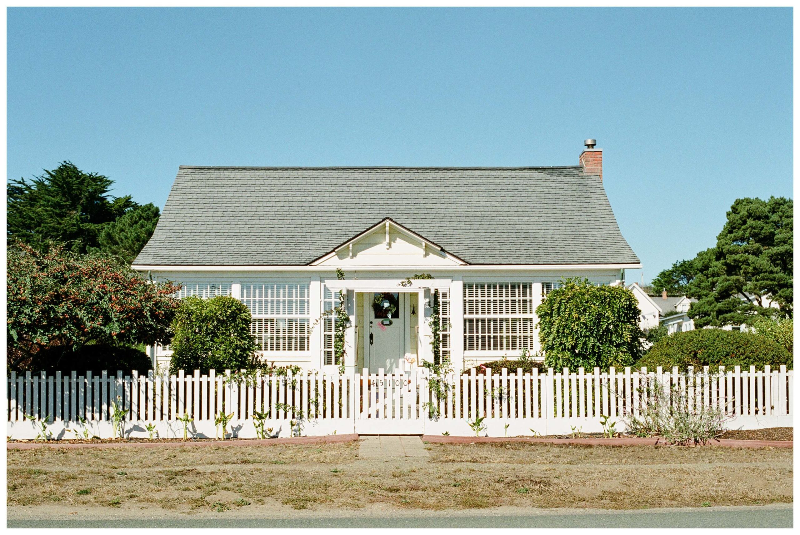 A white, single-story saltbox house in the northern California coastal town of Mendocino.