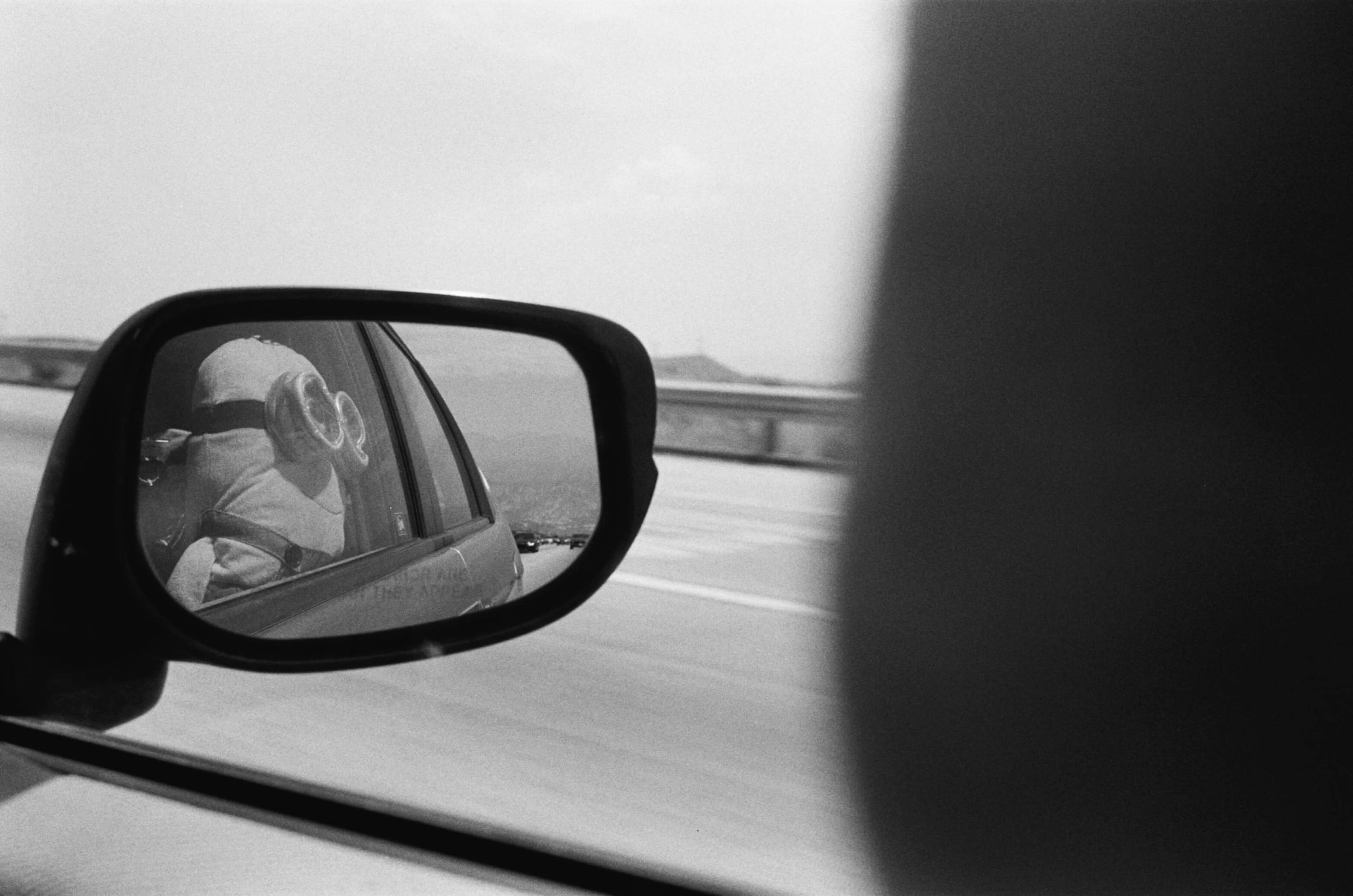 Rollei 35 sample image on Ilford HP5 film. minion stuffed toy looks out the car window in los angeles.