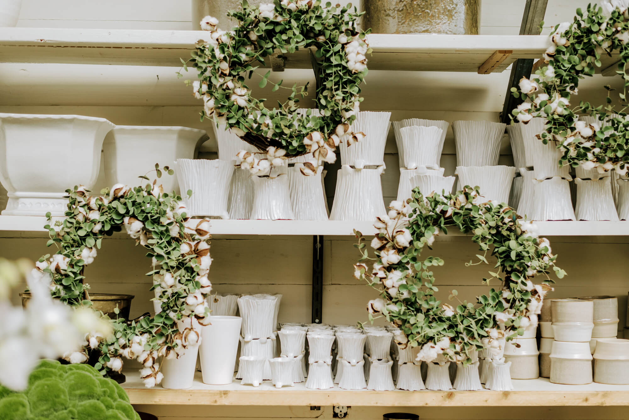 wreaths and ceramic white planters at Leaf and Petal Mountain Brook