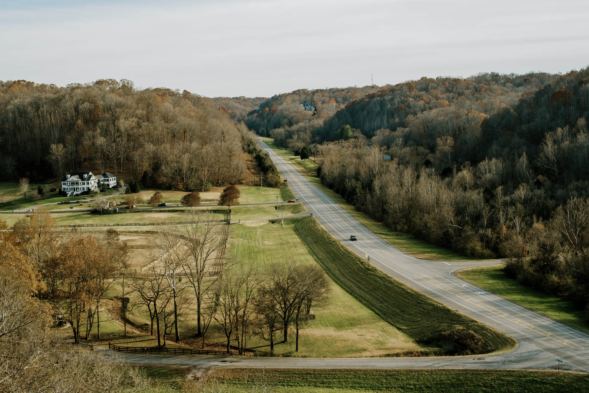a stretch of state route 96 on the Natchez Trace in Nashville, Tennessee. It is late fall and most of the trees are bare.