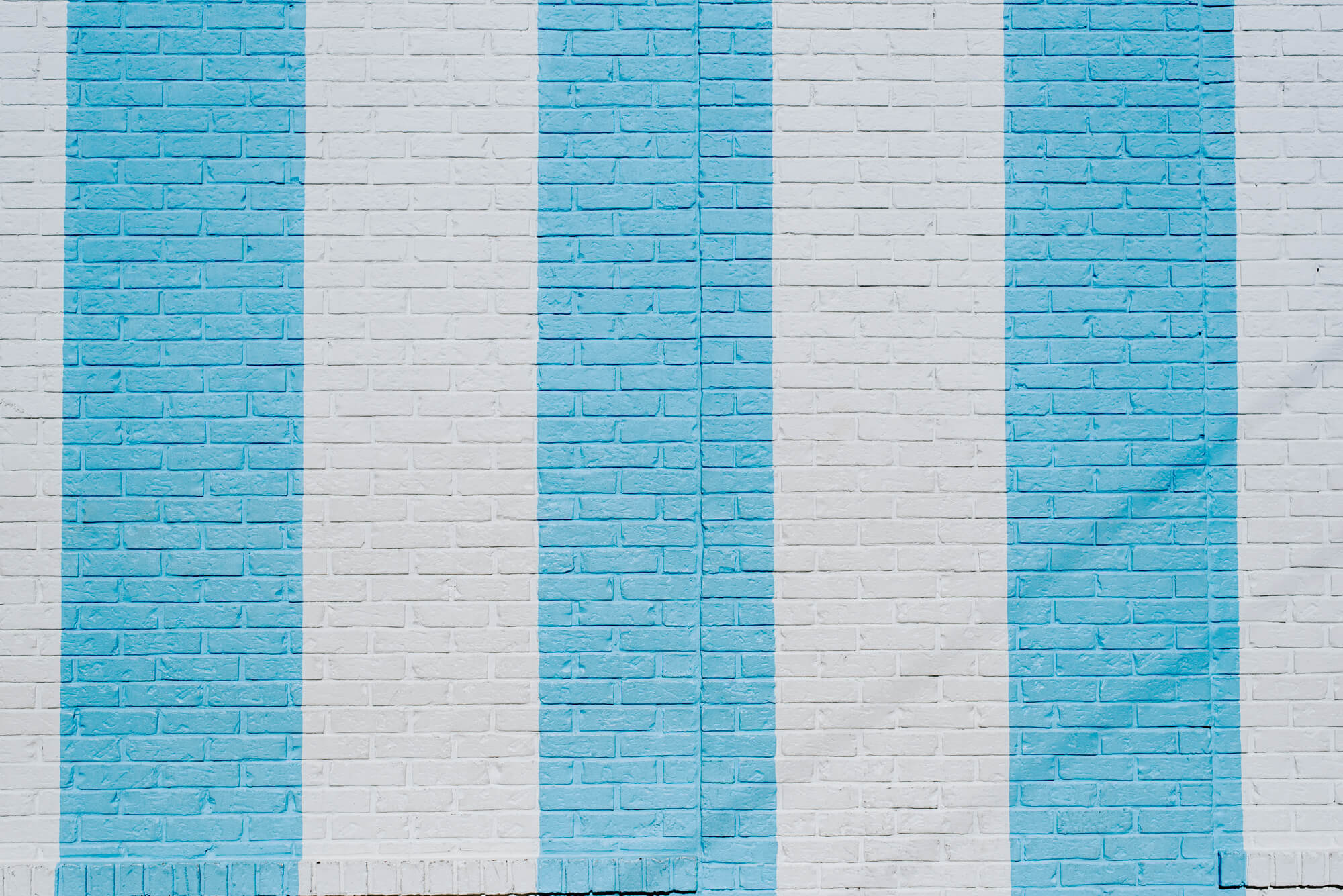 the bright blue and white striped mural on the brick wall of the Draper James store in 12 South Nashville
