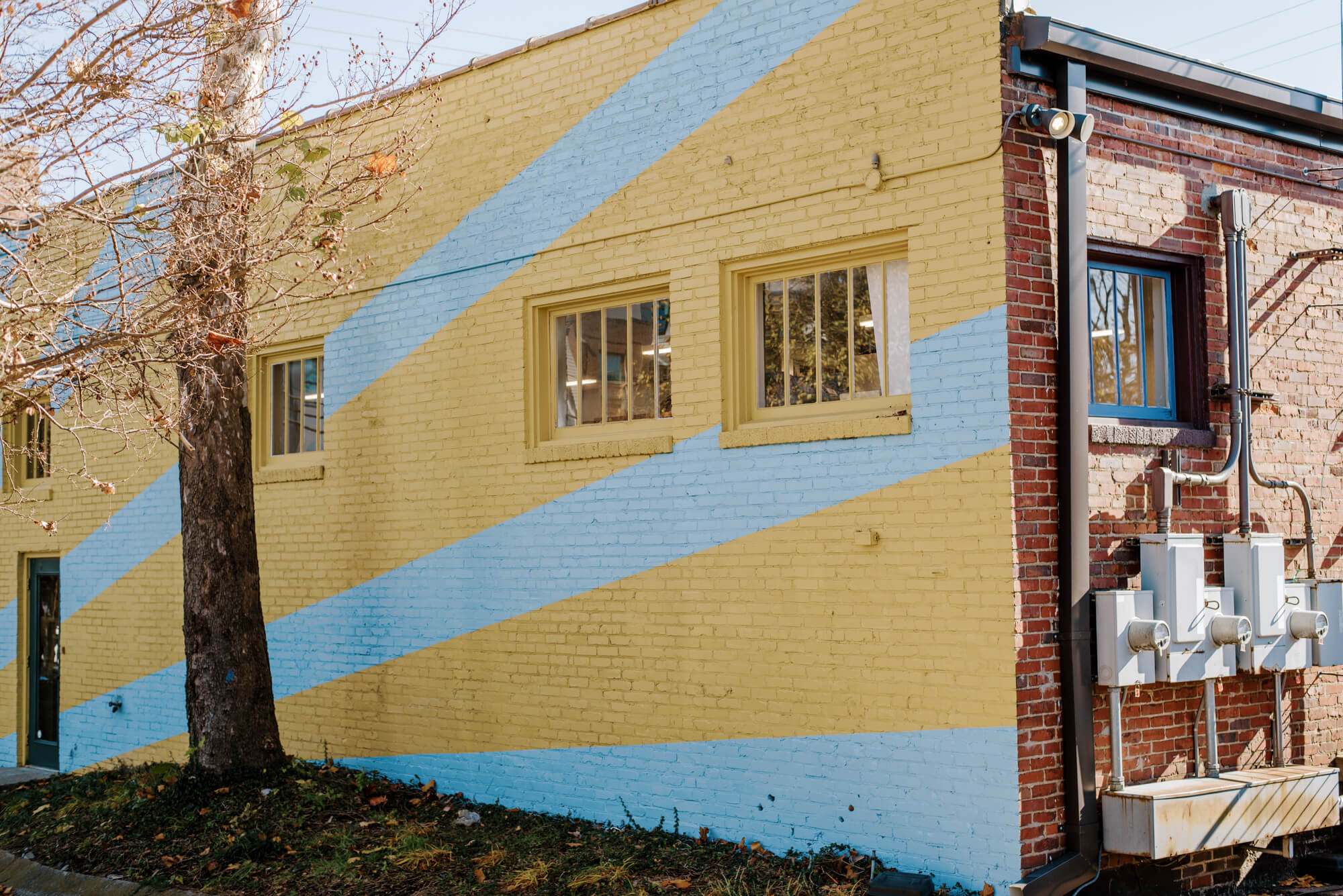 a mural in 12 South featuring sunny yellow and light blue diagonal stripes. 